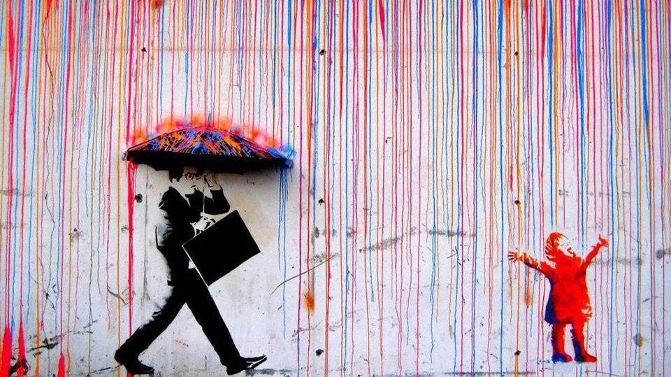 Street art of silhouetted figures on a colorful wall